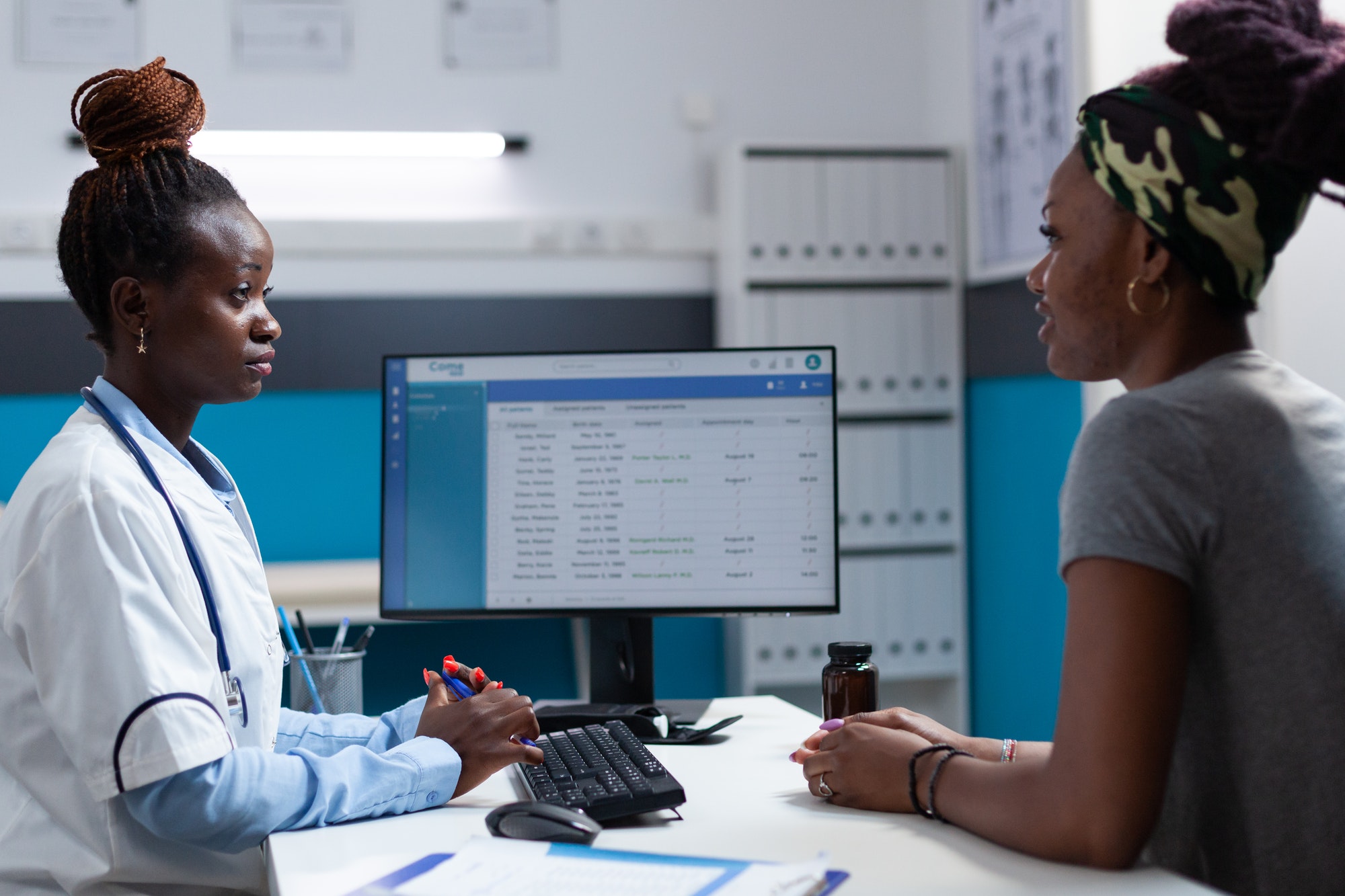 African american practitioner doctor discussing with patient