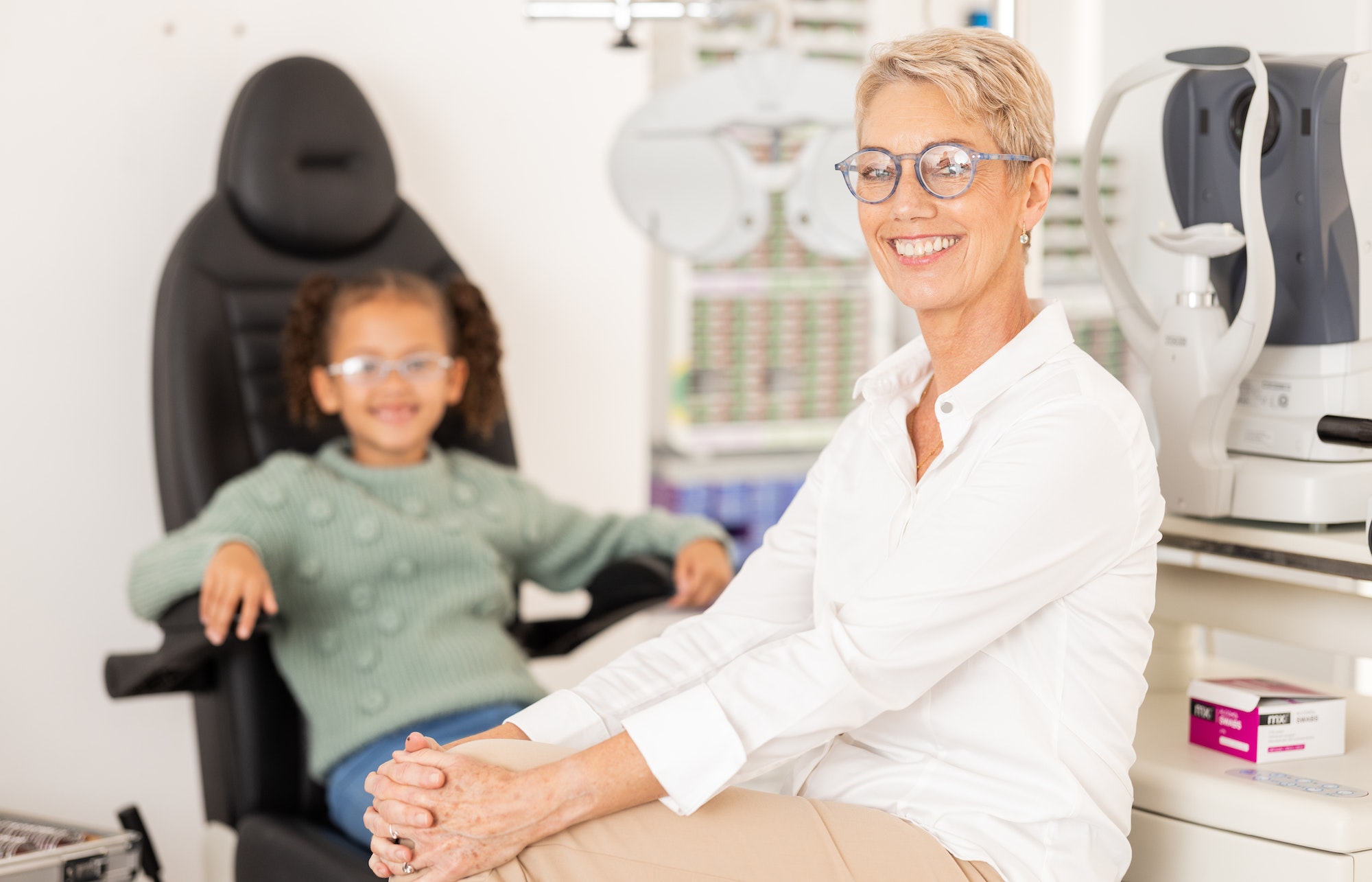 Ophthalmologist, child patient and vision test or eye exam for eye care to check and examine eyesig