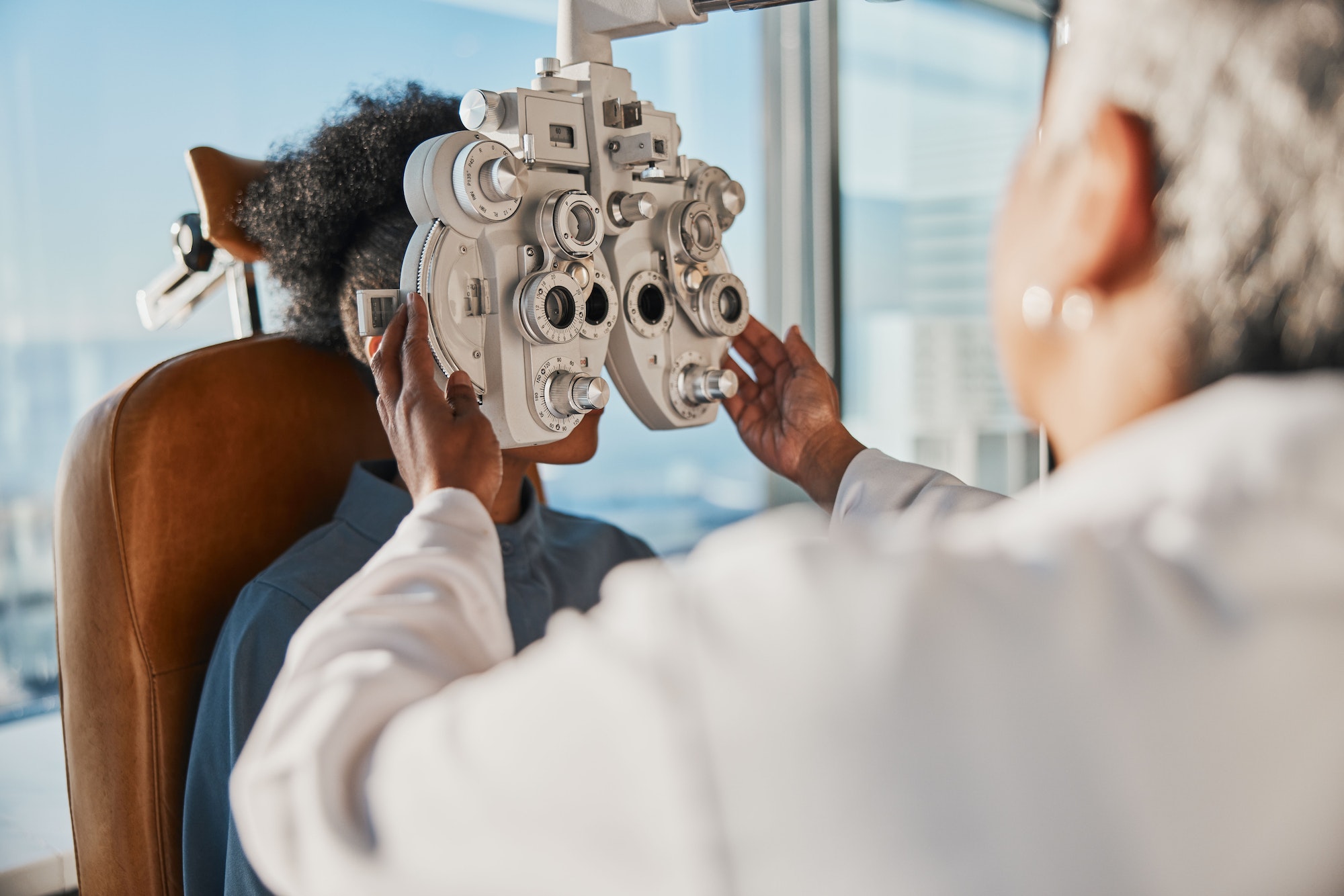 Optometry, healthcare and optometrist doing a eye test for a patient for vision or eyecare in a cli